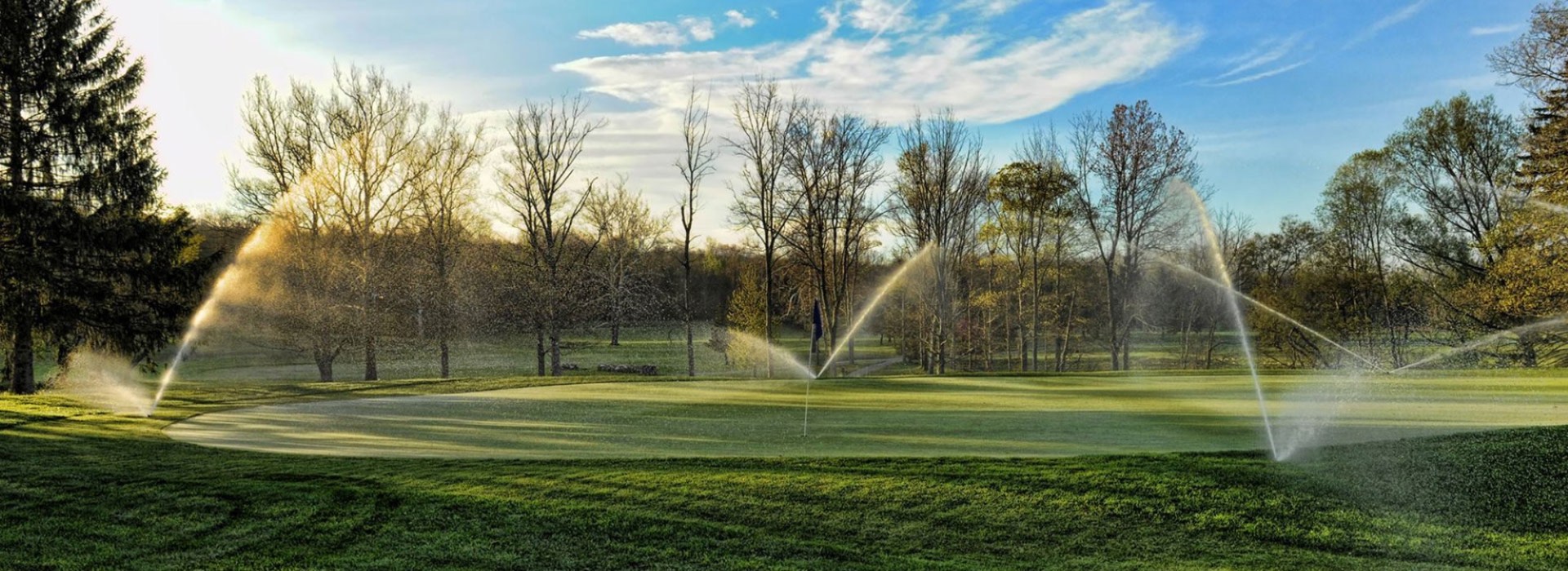 Golf course with running sprinklers